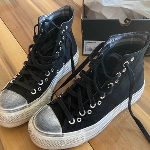 Black distressed (intentional) high top converse.